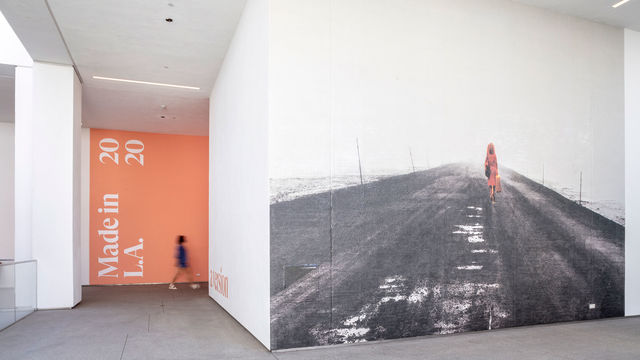 A hallway at the Hammer Museum, with a black-and-white photograph covering a whole wall, and a pink wall with Made in L.A. 2020 on it in the background